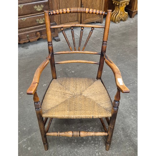 115 - A George III elm and fruitwood spindle back elbow chair