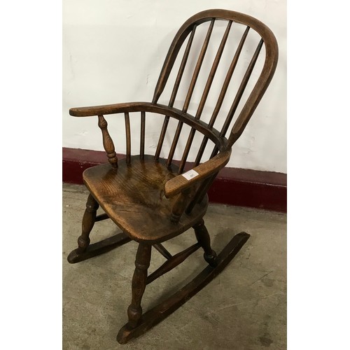 129 - A 19th Century child's elm Windsor rocking chair
