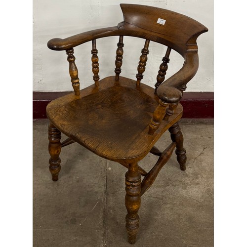 108 - A Victorian elm smokers bow armchair