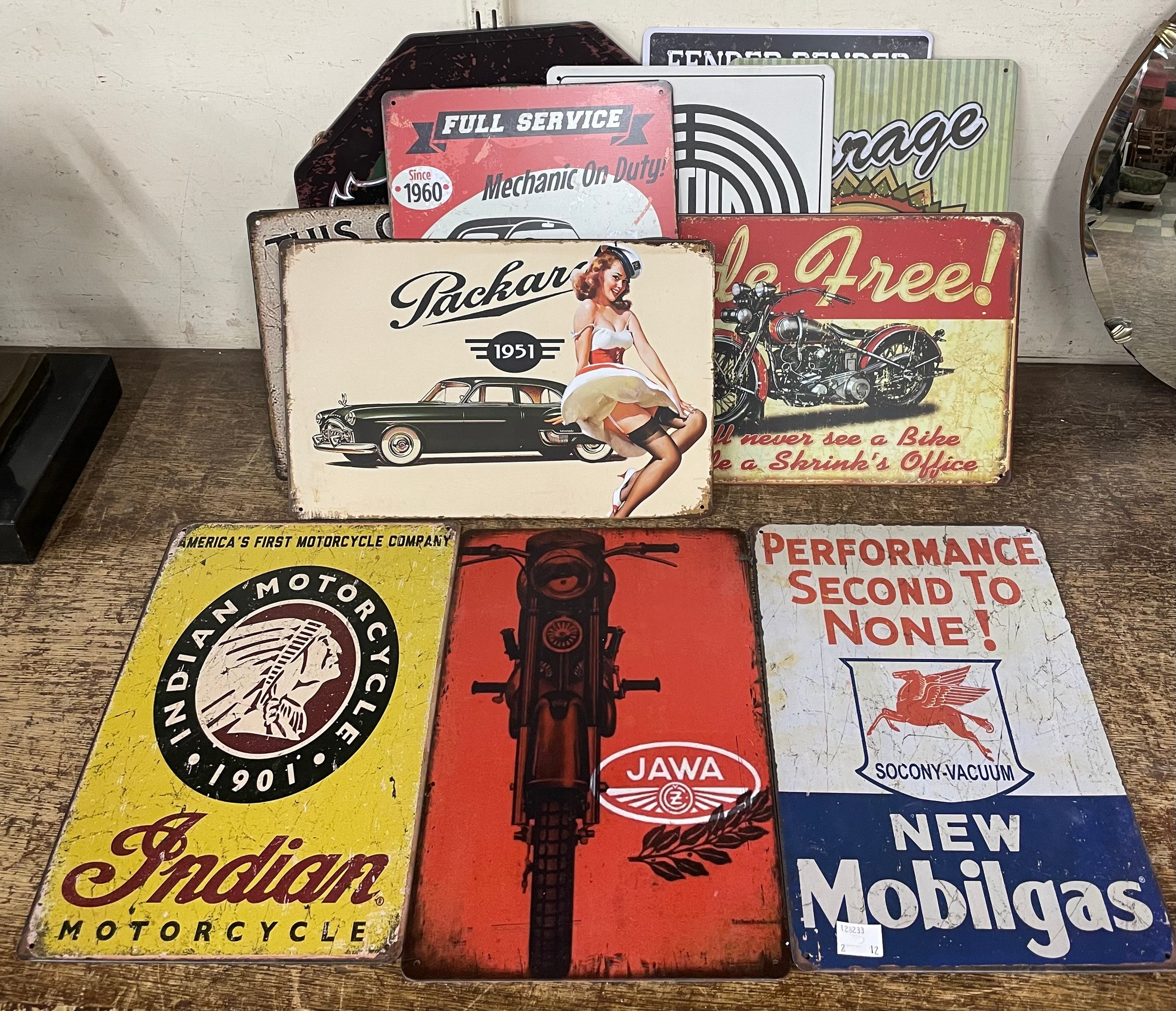 Twelve motoring related tin signs