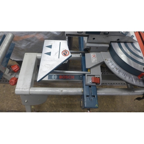 5211 - A Bosch Professional GCM85JL, 110V chop saw with a Bosch GTA2600 with saw stand and various accessor... 