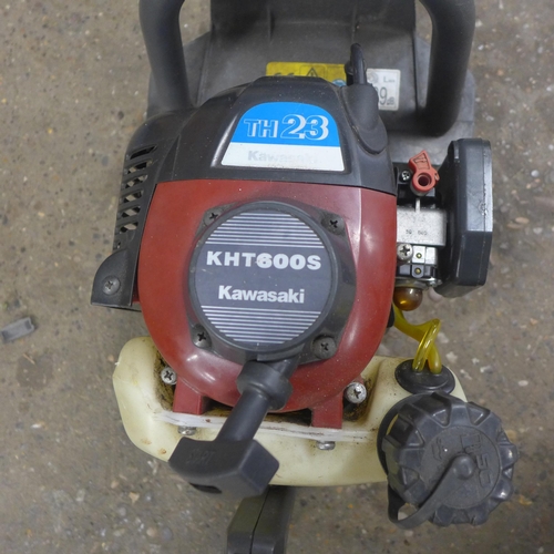 5214 - A petrol stone cutting saw, a Kawasaki KHT600S petrol hedge trimmer and 2 sack trucks