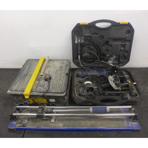 A manual tile cutter, a 230v 7