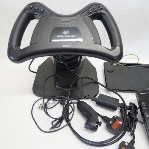 8053 - A quantity of gaming peripherals including, a Sega Saturn MK-80304 racing wheel, an Xbox Thrustmaste... 