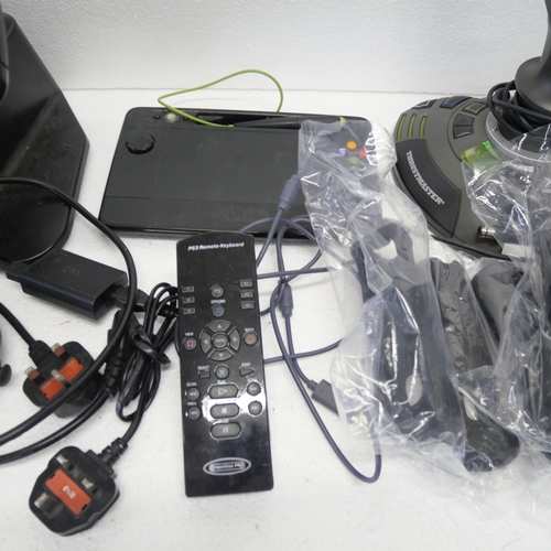 8053 - A quantity of gaming peripherals including, a Sega Saturn MK-80304 racing wheel, an Xbox Thrustmaste... 