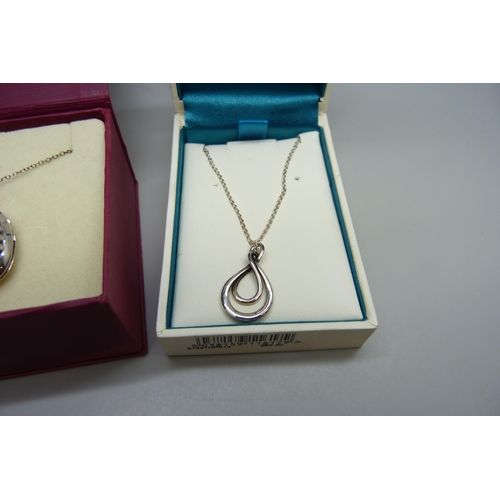 7015 - A silver Kit Heath pendant on a silver chain, and a silver locket with cross detail on a silver chai... 