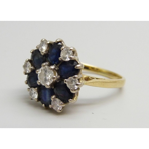 7022 - An 18ct gold, sapphire and diamond cluster ring, 4.2g, J/K