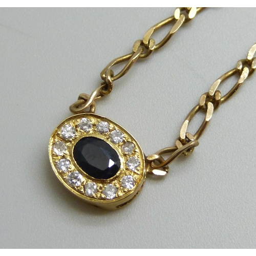 7023 - A 9ct gold curb link necklace with a sapphire and diamond cluster, 4.6g, 39cm