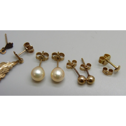 7027 - A pair of yellow metal drop earrings, a pair of yellow metal pearl stud earrings, the butterflies ma... 