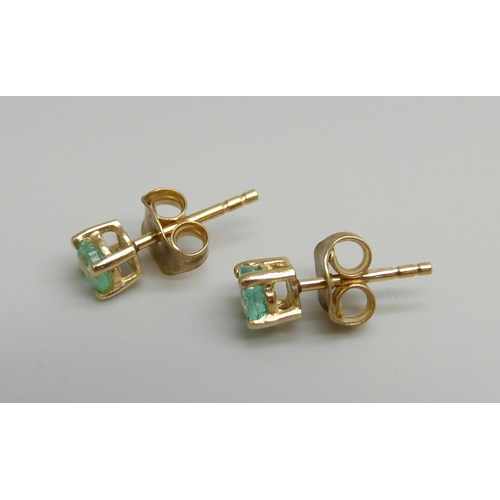 7039 - A pair of 14ct gold Columbian emerald stud earrings, 0.8g
