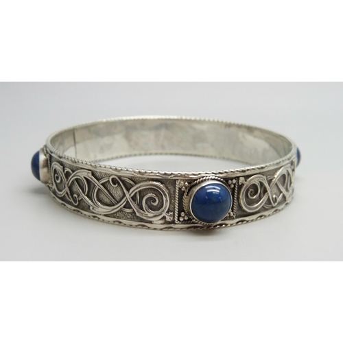 7049 - A silver stone set Celtic style bangle, 36g, 7.3cm