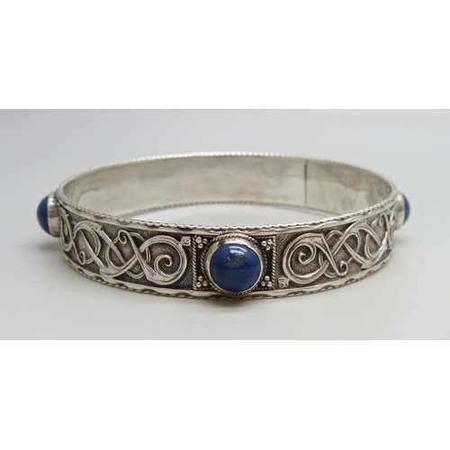7049 - A silver stone set Celtic style bangle, 36g, 7.3cm