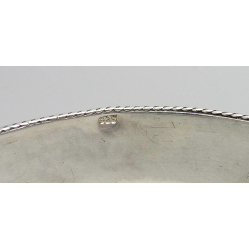 7049 - A silver stone set Celtic style bangle, 36g, 7.3cm