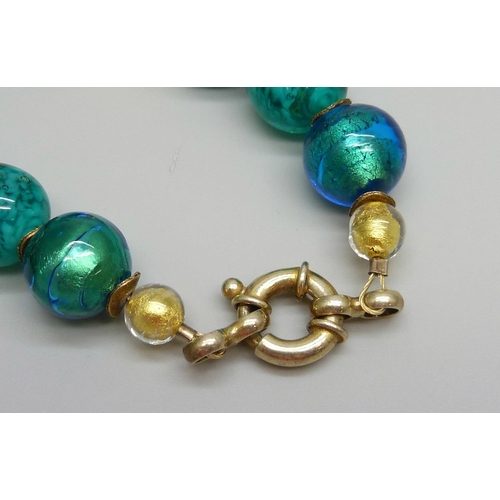 7050 - A silver gilt, foiled glass and Murano style bead necklace, the clasp marked 925, 45cm