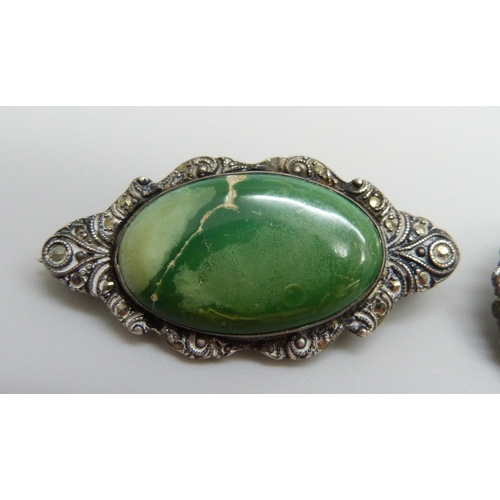 7052 - Two early 20th Century brooches, a white metal example set with a green stone and marcasite, 4.2cm, ... 