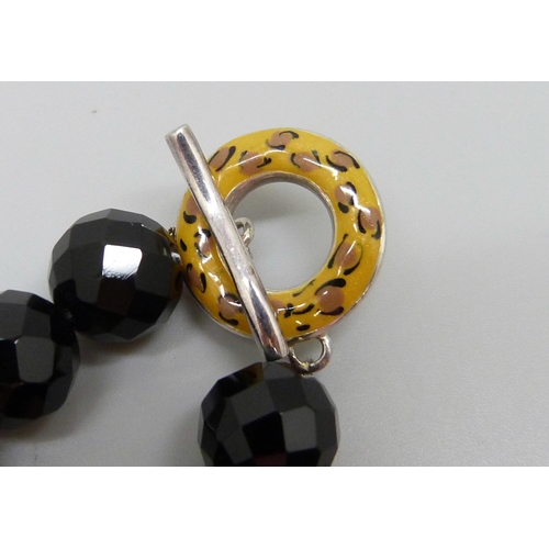 7058 - A silver and faceted black stone necklace, the clasp with leopard print and zebra enamel design and ... 