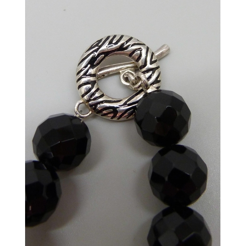 7058 - A silver and faceted black stone necklace, the clasp with leopard print and zebra enamel design and ... 