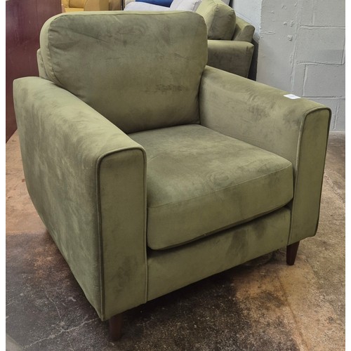 3117 - A moss green velvet upholstered armchair and matching pouffe