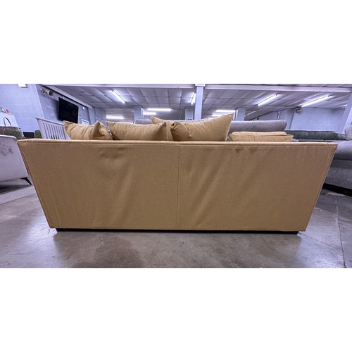 3121 - A mustard fabric upholstered three seater sofa, bagged