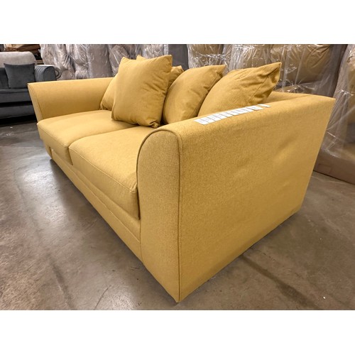 3125 - A mustard fabric upholstered three seater sofa, bagged