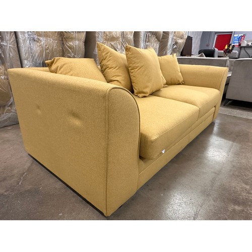 3125 - A mustard fabric upholstered three seater sofa, bagged