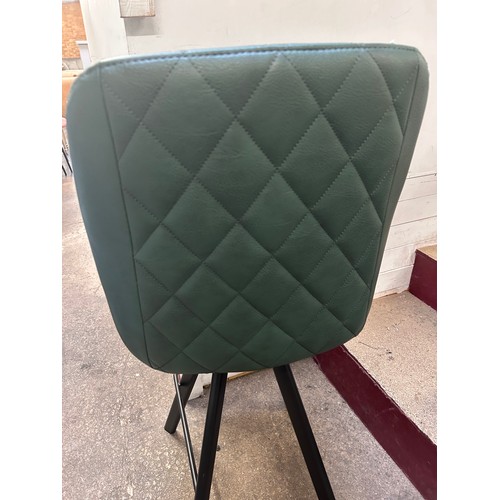 3132 - A racing green leather upholsted and black metal bar stool
