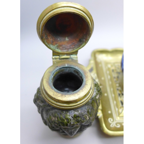 2043 - A brass inkstand with brass mounted ceramic inkwells and one other similar inkwell