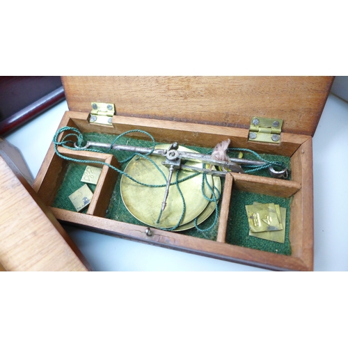 2044 - A Stanley rolling rule, boxed, two other boxes with wooden rulers, a cased set of balance scales wit... 