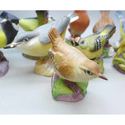 2045 - A collection of twelve Royal Worcester bird figures, a Hummel figure and a Corona Ware vase