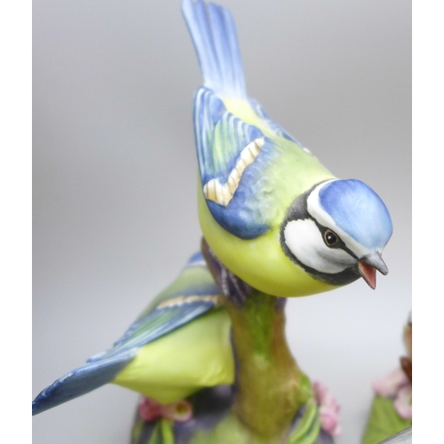 2045 - A collection of twelve Royal Worcester bird figures, a Hummel figure and a Corona Ware vase