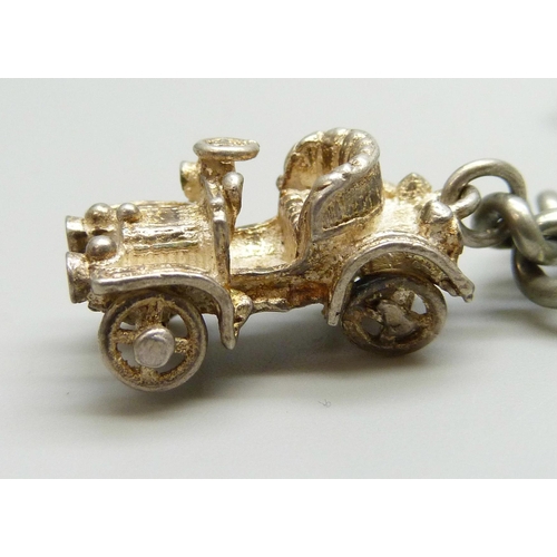 7177 - A silver plated double chain Albert bracelet, with two white metal charms, 20cm, dog clip and T bar ... 