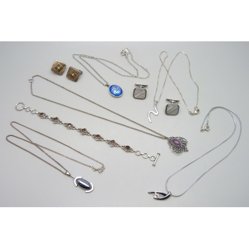 7180 - A collection of silver jewellery including an enamelled Celtic locket, .835 cufflinks, a white metal... 
