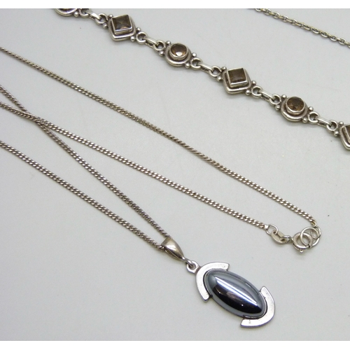 7180 - A collection of silver jewellery including an enamelled Celtic locket, .835 cufflinks, a white metal... 