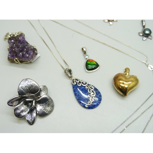 7192 - Seven silver pendants and four silver pendants with chains, 54g