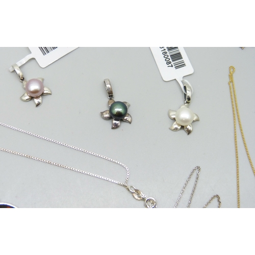 7192 - Seven silver pendants and four silver pendants with chains, 54g