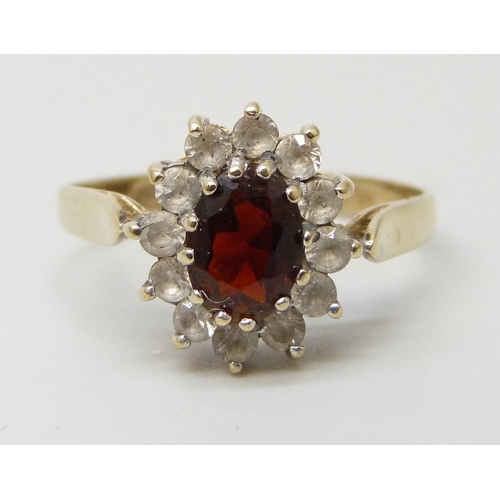 7197 - A 9ct gold, garnet and white stone cluster ring, 1.9g, O