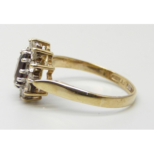 7197 - A 9ct gold, garnet and white stone cluster ring, 1.9g, O