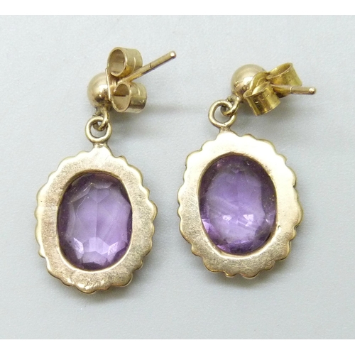 7203 - A pair of 9ct gold and amethyst drop earrings, unmatched butterflies, 3.3g total weight, 2.3cm