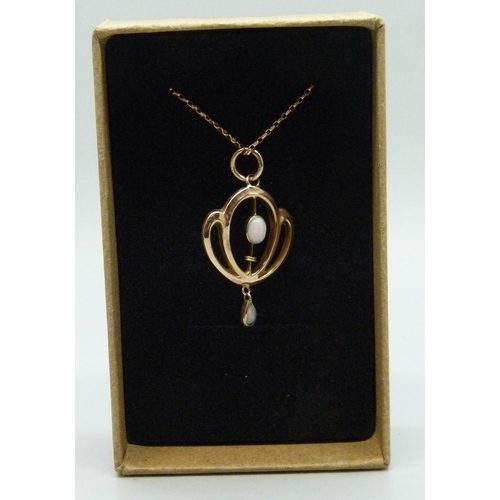 7211 - An Edwardian Art Nouveau 9ct rose gold and opal pendant, 3cm including bale, on a modern 9ct rose go... 