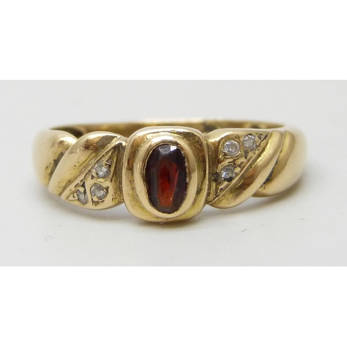 7218 - A yellow metal, garnet and white stone ring with control marks to outer shank, 3.1g, Q