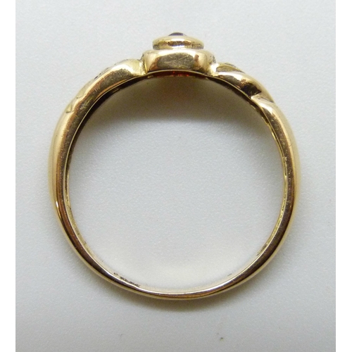 7218 - A yellow metal, garnet and white stone ring with control marks to outer shank, 3.1g, Q