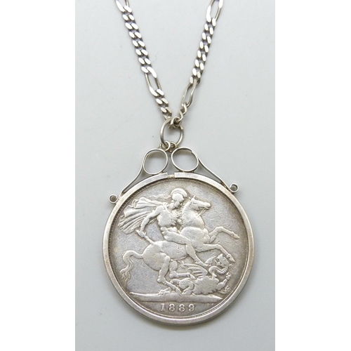 7219 - An 1889 Victorian crown in a white metal mount, on a silver figaro chain, 43g total weight