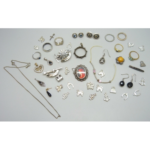 7221 - A collection of assorted earrings and charms, etc. some marked as silver