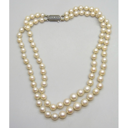 7230 - A double string of cultured pearls with a .800 silver clasp, 40g, 35cm