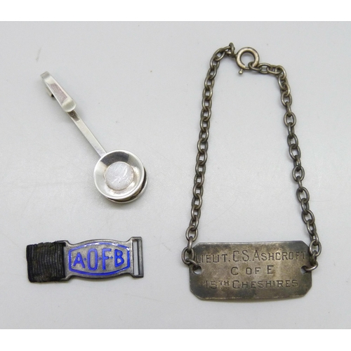 7231 - A boxed silver napkin holder, a silver identity bracelet engraved 'Lieut C.S. Ashcroft 15th Cheshire... 