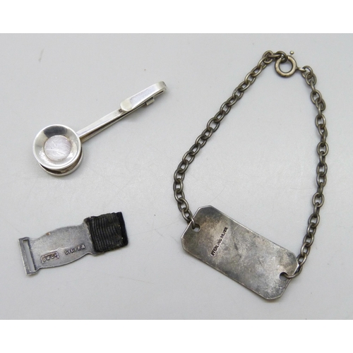 7231 - A boxed silver napkin holder, a silver identity bracelet engraved 'Lieut C.S. Ashcroft 15th Cheshire... 