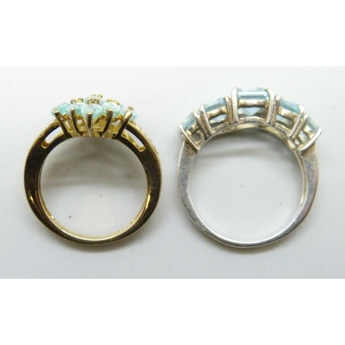 7238 - Two silver gilt rings set with blue stones, the cluster ring size L, the other size O/P
