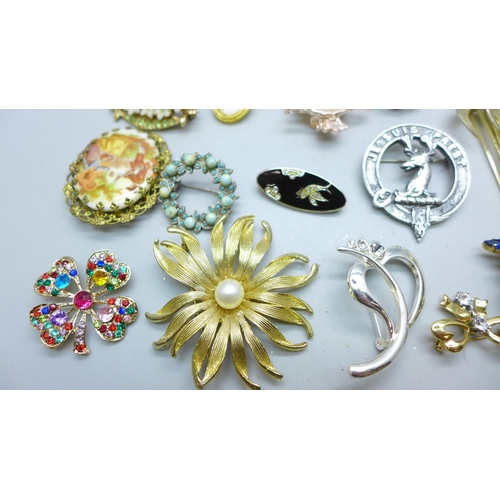 7251 - A collection of twenty two costume brooches and a scarf clip