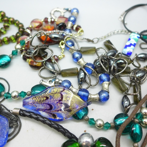 7273 - A collection of glass jewellery including pendants and necklaces