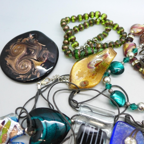 7273 - A collection of glass jewellery including pendants and necklaces